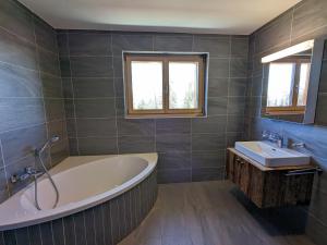 a large bathroom with a tub and a sink at Les Mayens MA 022 - LUXURY apart in Veysonnaz