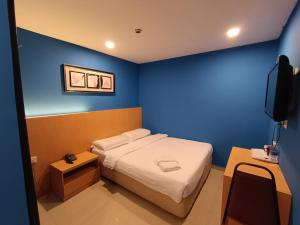 Postel nebo postele na pokoji v ubytování South of The Clouds HOTEL KL Sentral 吉隆坡彩云之南酒店-中央车站店