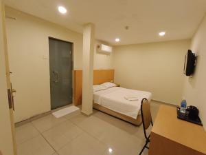 Postel nebo postele na pokoji v ubytování South of The Clouds HOTEL KL Sentral 吉隆坡彩云之南酒店-中央车站店