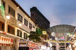 a street with buildings and christmas lights in a city at Heritage Collection on Pagoda - Mobile App Check-In in Singapore