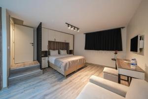 a hotel room with a bed and a couch at Nuru Ziya Residences in Istanbul