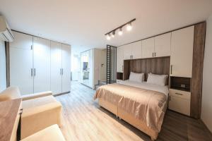 a bedroom with a large bed and white cabinets at Nuru Ziya Residences in Istanbul