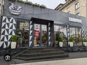 a store front with potted plants in front of it at Studios on Grigore Vieru in Chişinău