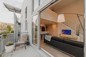 a balcony with a view of a kitchen and a living room at CBD Edge - 2BR Home with Balcony Sleeps 4 in Christchurch