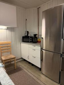 a kitchen with a stainless steel refrigerator and a microwave at Central and spacious with 3 bedrooms and beds for 10 persons in Alta