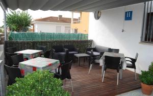 a group of tables and chairs on a patio at Hotel Paradís in Torredembarra