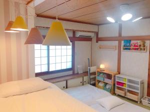 a bedroom with two beds and a window at RInnオリジナル天下茶屋 松 in Osaka