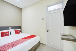 Postel nebo postele na pokoji v ubytování Krekot Residence Pasar Baru