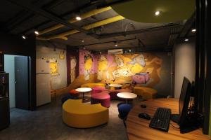 a room with tables and stools and a computer at Backpackers Hostel - Ximen in Taipei