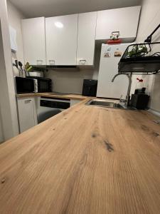 a kitchen with a wooden counter top with a sink at Pamplona Home in Pamplona