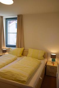 a bedroom with two beds and a window at Inselblume 50 - Ferienwohnung von privat in der Strandburg in Burgtiefe auf Fehmarn  +22 photos