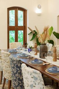 a dining room table with glasses and chairs at LohonoStays Villa Brisa in Anjuna