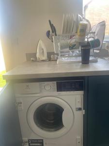 a washing machine with a counter top on top of it at DFL's Lovely Home in Rotherham