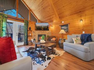 a living room with a couch and a fireplace at Cottage In The Pines #297 in Sevierville