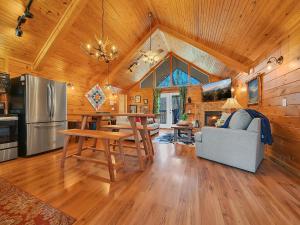a kitchen and living room of a log cabin at Cottage In The Pines #297 in Sevierville