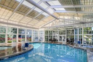 a large swimming pool in a large building with windows at Pigeon Forge Adventure #163 in Pigeon Forge