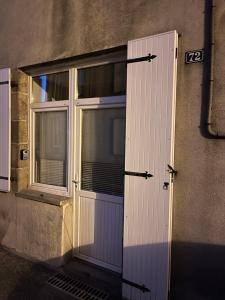 a door with a window on the side of a building at Chez Joseph in Mauléon