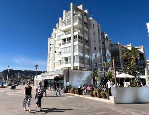 two people walking in front of a large building at Europa II in Calpe
