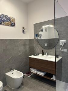 a bathroom with a sink and a mirror at Zeta Boutique in Caserta