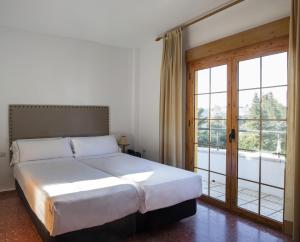 Postel nebo postele na pokoji v ubytování Hotel Tugasa El Almendral