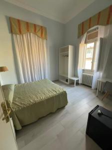 a bedroom with a bed and a window at Hotel Ely in Viareggio
