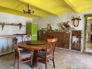 a dining room with a wooden table and chairs at Vamiš Apartment in Stanjevci