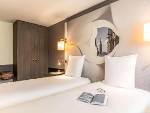 Postel nebo postele na pokoji v ubytování Mercure Metz Centre
