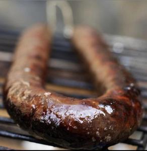 a row of hot dogs cooking on a grill at Domaine l Alba Scelta in Ucciani