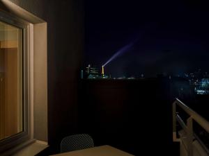 a room with a view of a city at night at ibis budget Issy Les Moulineaux Paris Ouest in Issy-les-Moulineaux
