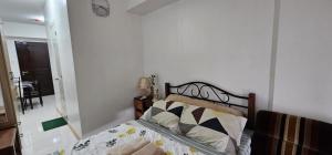 a bedroom with a bed and a mirror at Homey822 in Davao City +7 photos