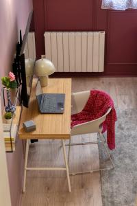 a wooden desk with a laptop and a chair at Chronos by Kleidos, Grand duplex, 4 personnes, 3 minutes Gros Horloge & Opéra de Rouen in Rouen +63 photos