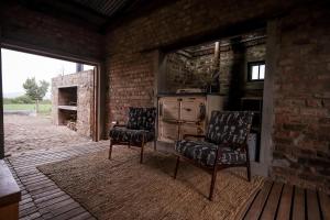 a kitchen with two chairs and an old stove at The RamShed in Middelburg