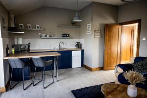 a kitchen with a counter and a table in a room at Noel's Place in Doolin