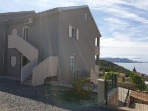 a building with stairs on the side of it at Slavica Apartments 3a in Sveti Juraj