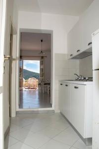 cocina blanca con vistas a una mesa en Residence Capo Morcone, en Capoliveri