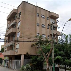 a tallartment building with a tree in front of it at Apto no Centro de São Leopoldo in São Leopoldo