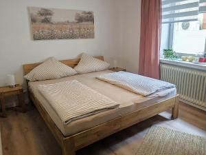 a bed in a room with a window at Gästehaus Zeller Altstadt in Zell an der Mosel
