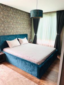 a bedroom with a blue bed in a room at Luxury Park Villa in Sandanski