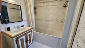 a bathroom with a sink and a shower and a tub at La Cour d'Arblade in Arblade-le-Haut +26 photos