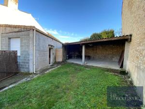 an empty courtyard of a building with a grass yard at La Maison du Chapron - Jaunay Marigny - Futuroscope in Jaunay-Marigny