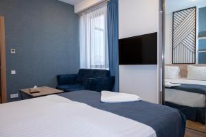 Voodi või voodid majutusasutuse Rooftop Hotel toas