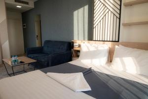 Voodi või voodid majutusasutuse Rooftop Hotel toas