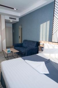 Voodi või voodid majutusasutuse Rooftop Hotel toas