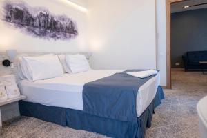 Voodi või voodid majutusasutuse Rooftop Hotel toas