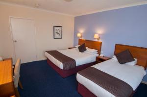 A bed or beds in a room at The Bell Hotel 