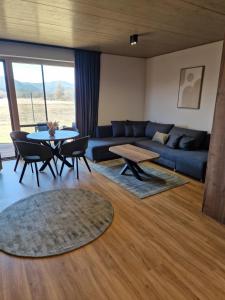 a living room with a couch and a table and chairs at Apartments LFCI - Hrabušice in Hrabušice