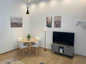 a living room with a table and a flat screen tv at Apartamento Murcia San José C in Murcia