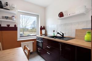 a kitchen with a sink and a window at Meer-Natur-Idyll in Peenemünde