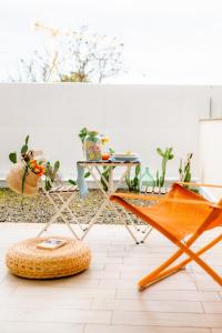 a table and a chair in a room at Opuntia Home in Monopoli