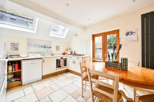 a kitchen and dining room with a table and chairs at GuestReady - Charming family retreat in London in London